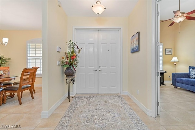 7810 Twin Eagle Ln, Fort Myers, FL 33912 - foyer with light tile patterned floors, ceiling fan, and baseboards
