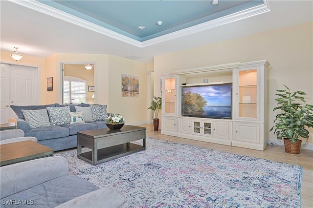 7810 Twin Eagle Ln, Fort Myers, FL 33912 - tiled living area featuring crown molding, a raised ceiling, and baseboards