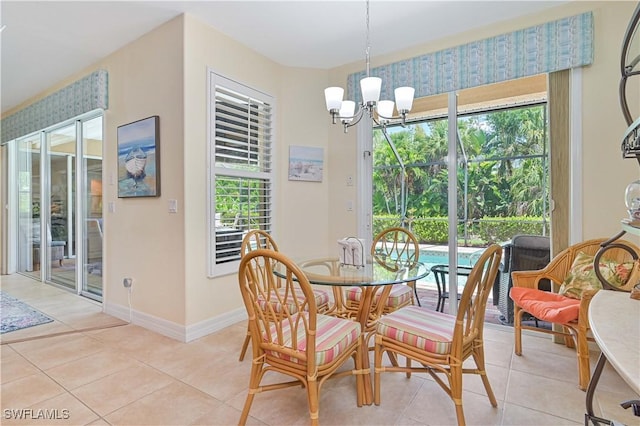 7810 Twin Eagle Ln, Fort Myers, FL 33912 - dining area with a chandelier, light tile patterned flooring, and baseboards