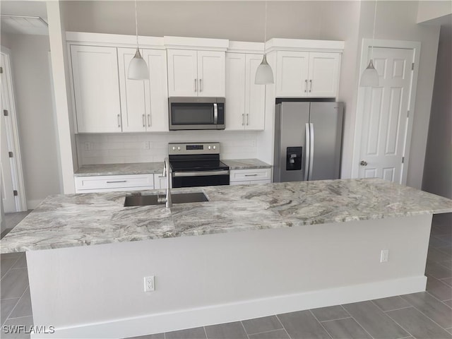 3607 SW 8th Ct, Cape Coral, FL 33914 - kitchen featuring appliances with stainless steel finishes, a sink, tasteful backsplash, and white cabinets