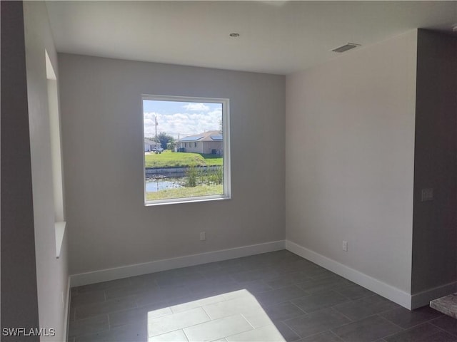 3607 SW 8th Ct, Cape Coral, FL 33914 - spare room with dark tile patterned flooring and baseboards