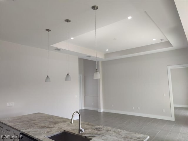 3607 SW 8th Ct, Cape Coral, FL 33914 - kitchen with a sink, a raised ceiling, wood finished floors, light stone counters, and recessed lighting