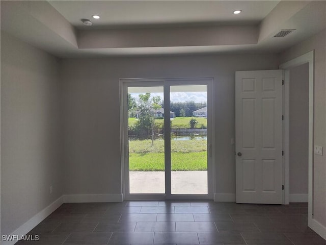 3607 SW 8th Ct, Cape Coral, FL 33914 - doorway with a tray ceiling, baseboards, dark tile patterned floors, and recessed lighting