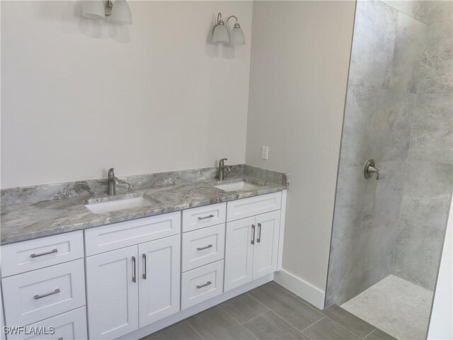 3607 SW 8th Ct, Cape Coral, FL 33914 - bathroom with walk in shower, double vanity, and baseboards