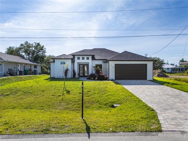 3607 SW 8th Ct, Cape Coral, FL 33914 - prairie-style house featuring french doors, an attached garage, stucco siding, a front lawn, and decorative driveway