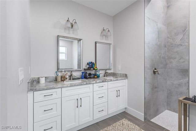3607 SW 8th Ct, Cape Coral, FL 33914 - full bathroom featuring a walk in shower, double vanity, and wood finished floors