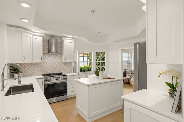 4485 Dover Ct Unit 1202, Naples, FL 34105 - kitchen featuring appliances with stainless steel finishes, wall chimney exhaust hood, a sink, backsplash, and a center island
