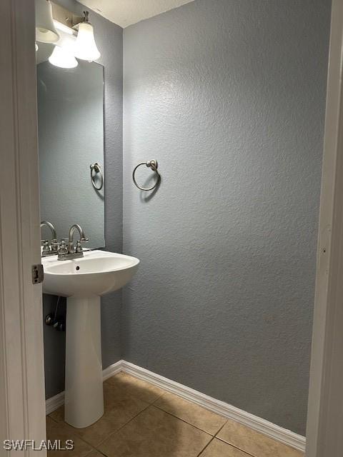 6370 Brant Bay Blvd Unit 105, North Fort Myers, FL 33917 - bathroom with tile patterned flooring, baseboards, and a sink