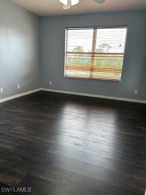 6370 Brant Bay Blvd Unit 105, North Fort Myers, FL 33917 - unfurnished room featuring dark wood-type flooring, baseboards, and a ceiling fan