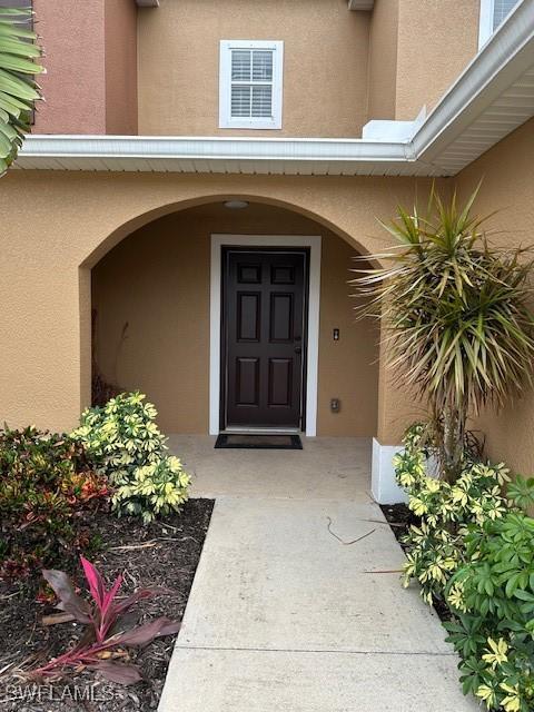 6370 Brant Bay Blvd Unit 105, North Fort Myers, FL 33917 - view of exterior entry with stucco siding