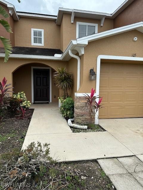6370 Brant Bay Blvd Unit 105, North Fort Myers, FL 33917 - property entrance with stucco siding and an attached garage