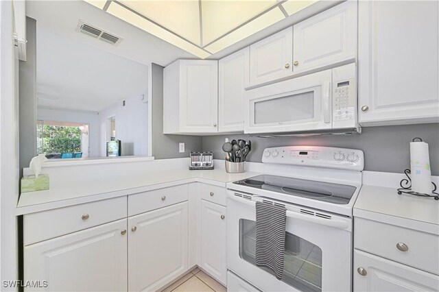 26735 Little John Ct Unit 25, Bonita Springs, FL 34135 - kitchen featuring white appliances, light countertops, and white cabinetry