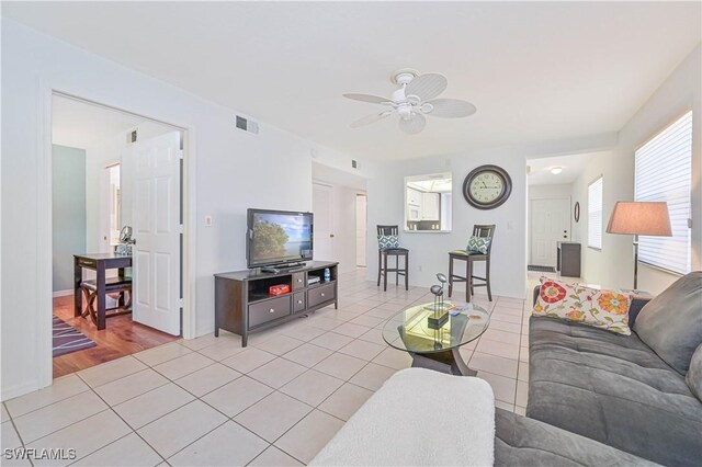 26735 Little John Ct Unit 25, Bonita Springs, FL 34135 - living area featuring ceiling fan, light tile patterned floors, and baseboards