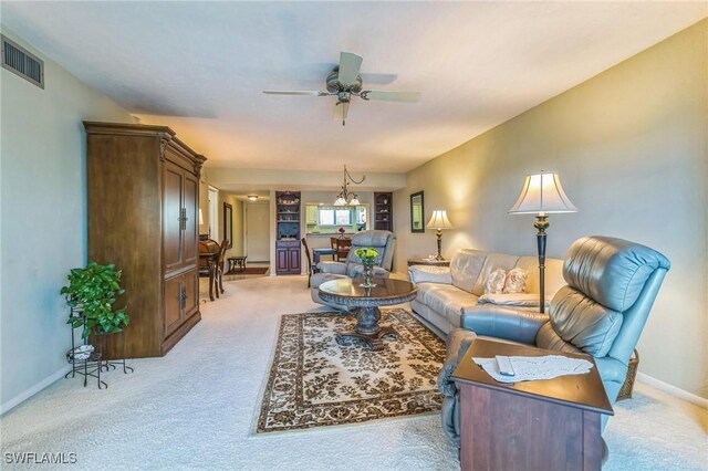 226 3rd St Unit 208, Bonita Springs, FL 34134 - living area featuring light colored carpet, a ceiling fan, and baseboards