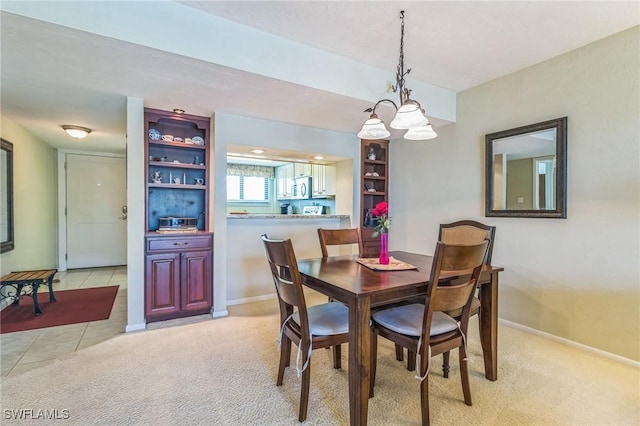 226 3rd St Unit 208, Bonita Springs, FL 34134 - dining area featuring light colored carpet and baseboards
