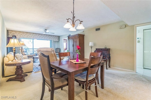 226 3rd St Unit 208, Bonita Springs, FL 34134 - dining area with light colored carpet, a chandelier, baseboards, and a ceiling fan