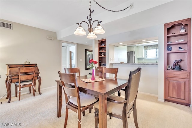 226 3rd St Unit 208, Bonita Springs, FL 34134 - dining space featuring light colored carpet, a chandelier, baseboards, recessed lighting, and built in shelves