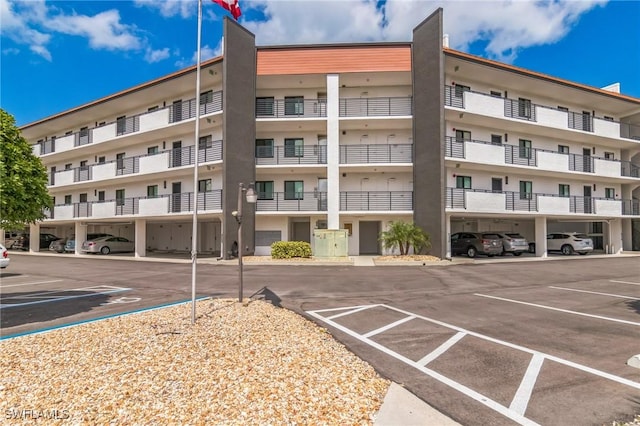 226 3rd St Unit 208, Bonita Springs, FL 34134 - view of apartment building / complex featuring covered and uncovered parking
