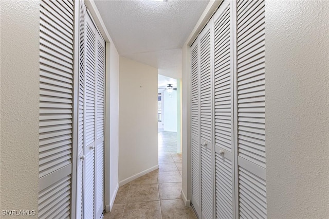 3460 N Key Dr Unit 210, North Fort Myers, FL 33903 - hall with a textured ceiling, light tile patterned floors, and baseboards