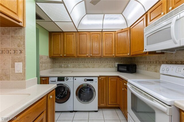 3460 N Key Dr Unit 210, North Fort Myers, FL 33903 - washroom with washer and dryer and light tile patterned floors