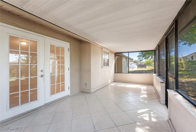 unfurnished sunroom featuring french doors