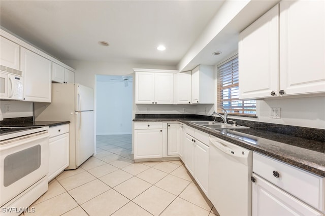 kitchen featuring white appliances, a sink, white cabinets, light tile patterned floors, and recessed lighting