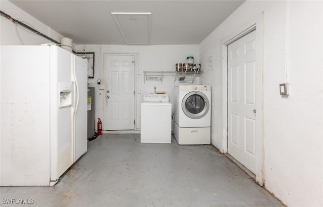 washroom featuring washer and dryer, water heater, and attic access