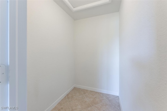 unfurnished room featuring light tile patterned floors and baseboards