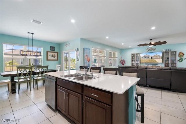 1713 NW 9th Ter, Cape Coral, FL 33993 - kitchen featuring stainless steel dishwasher, light countertops, a kitchen island with sink, healthy amount of natural light, and recessed lighting