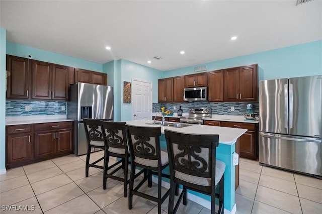 1713 NW 9th Ter, Cape Coral, FL 33993 - kitchen featuring stainless steel appliances, light countertops, backsplash, light tile patterned flooring, and recessed lighting