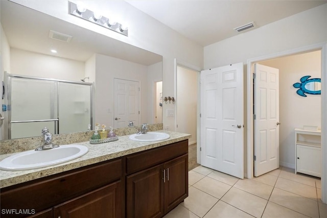 1713 NW 9th Ter, Cape Coral, FL 33993 - full bathroom with double vanity, tile patterned flooring, and a stall shower