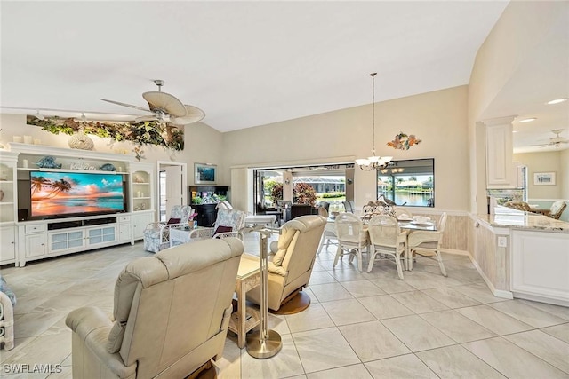 170 June Ct, Marco Island, FL 34145 - living room featuring ceiling fan, lofted ceiling, a chandelier, wainscoting, and light tile patterned floors