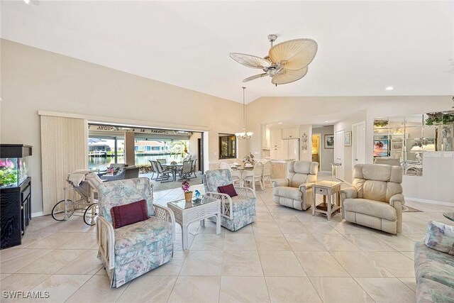 170 June Ct, Marco Island, FL 34145 - living area with a chandelier, a ceiling fan, light tile patterned floors, baseboards, and high vaulted ceiling