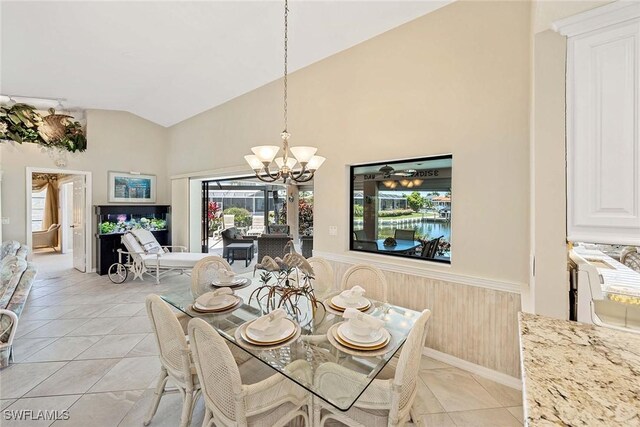 170 June Ct, Marco Island, FL 34145 - dining area with wainscoting, a chandelier, light tile patterned floors, high vaulted ceiling, and wooden walls