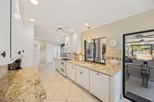 170 June Ct, Marco Island, FL 34145 - kitchen featuring white appliances, a ceiling fan, a sink, white cabinetry, and light stone counters
