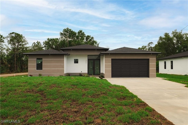 3201 18th St W, Lehigh Acres, FL 33971 - prairie-style house featuring concrete driveway, stucco siding, and a front yard