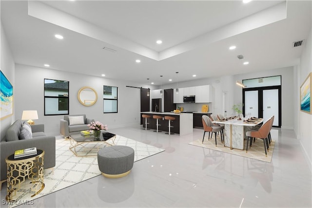 3201 18th St W, Lehigh Acres, FL 33971 - living room featuring a barn door, recessed lighting, and baseboards