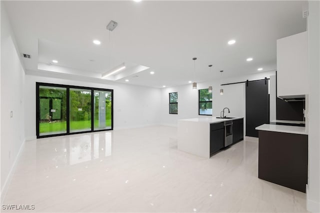 3201 18th St W, Lehigh Acres, FL 33971 - kitchen featuring light countertops, modern cabinets, dishwasher, a sink, and a barn door