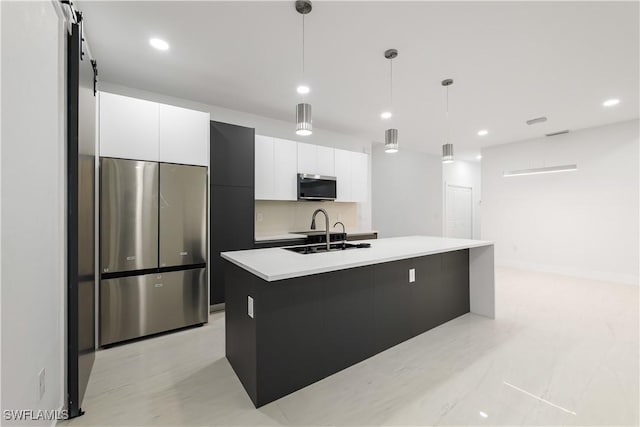 3201 18th St W, Lehigh Acres, FL 33971 - kitchen featuring appliances with stainless steel finishes, modern cabinets, white cabinetry, an island with sink, and a sink