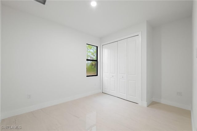 3201 18th St W, Lehigh Acres, FL 33971 - unfurnished bedroom featuring a closet, baseboards, and recessed lighting