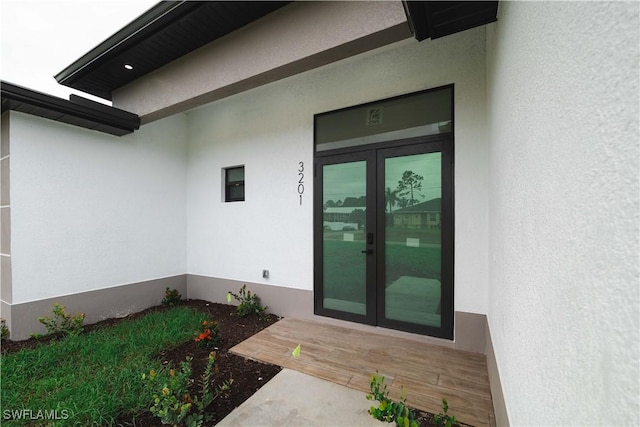 3201 18th St W, Lehigh Acres, FL 33971 - view of exterior entry featuring french doors and stucco siding