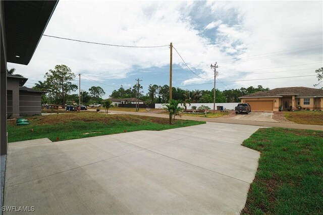 3201 18th St W, Lehigh Acres, FL 33971 - view of front of house featuring driveway and a front yard