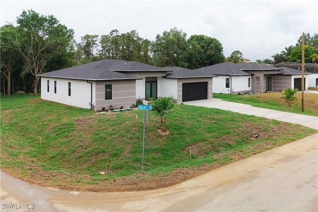 3201 18th St W, Lehigh Acres, FL 33971 - view of front facade with concrete driveway, an attached garage, stucco siding, a front lawn, and a shingled roof