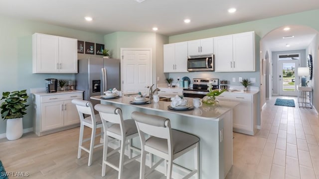 927 Joponica Ave S, Lehigh Acres, FL 33974 - kitchen with appliances with stainless steel finishes, a breakfast bar, white cabinetry, and recessed lighting