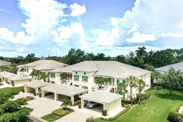 15040 Sandpiper Preserve Blvd Unit 201, Fort Myers, FL 33919 - rear view of property featuring concrete driveway and a yard