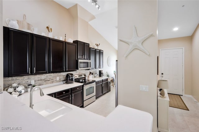 15040 Sandpiper Preserve Blvd Unit 201, Fort Myers, FL 33919 - kitchen with appliances with stainless steel finishes, a sink, backsplash, and light tile patterned flooring
