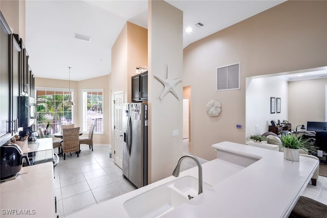 15040 Sandpiper Preserve Blvd Unit 201, Fort Myers, FL 33919 - kitchen with appliances with stainless steel finishes, a sink, light countertops, high vaulted ceiling, and light tile patterned flooring