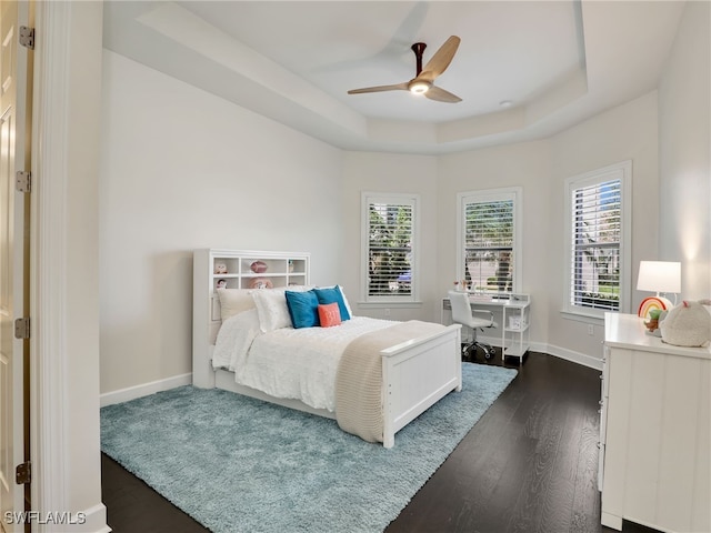 16289 Camden Lakes Cir, Naples, FL 34110 - bedroom with a raised ceiling, dark wood finished floors, baseboards, and an office area