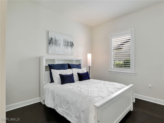 16289 Camden Lakes Cir, Naples, FL 34110 - bedroom with dark wood-style floors and baseboards