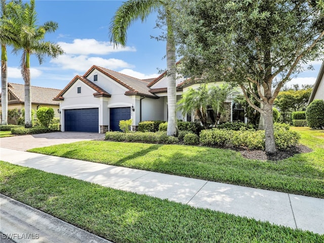 16289 Camden Lakes Cir, Naples, FL 34110 - view of front of house with stucco siding, a front yard, driveway, and an attached garage